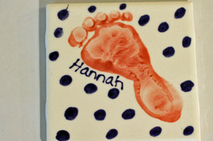 Finished footprint tile from paint your own pottery studio